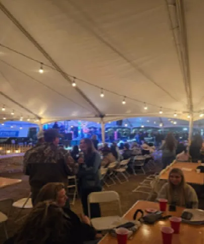 The event tent filling up before service.