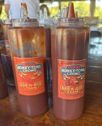 Bottles of Texas Honky-Tonk Crowd BBQ sauce.